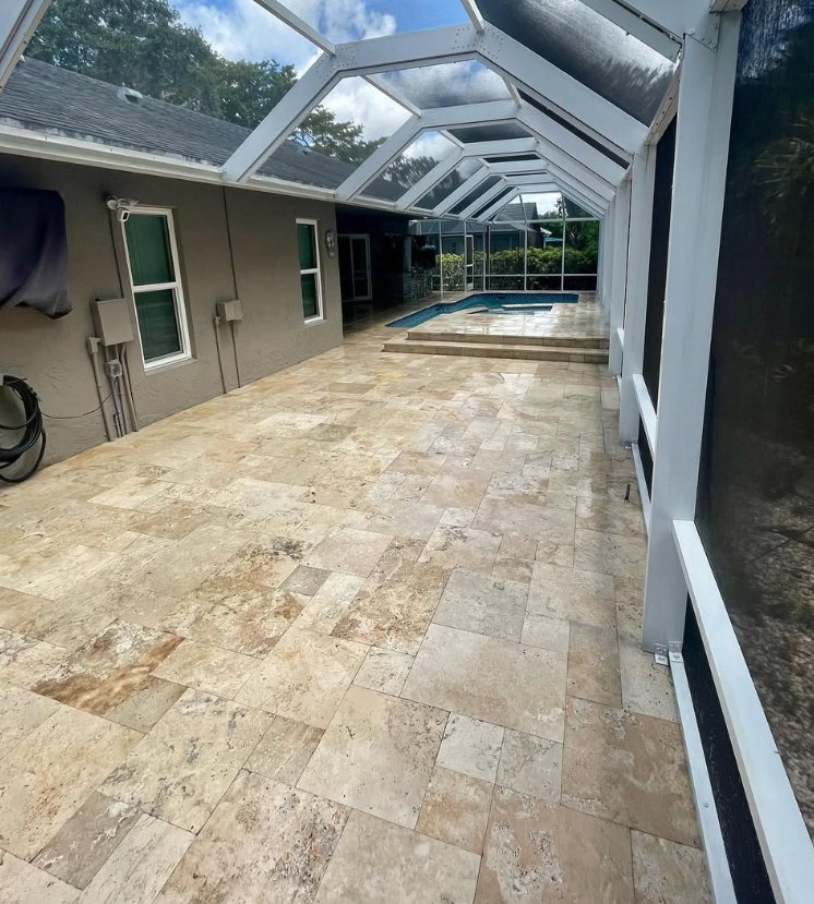 Screened lanai with travertine pavers cleaned back to a warm tone