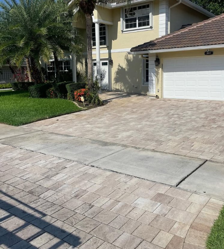 Travertine paver driveway dulled by dirt and organic growth before cleaning