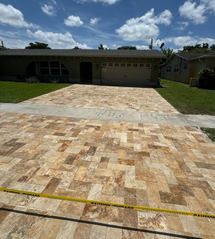 Finished travertine paver driveway taped off after sealing